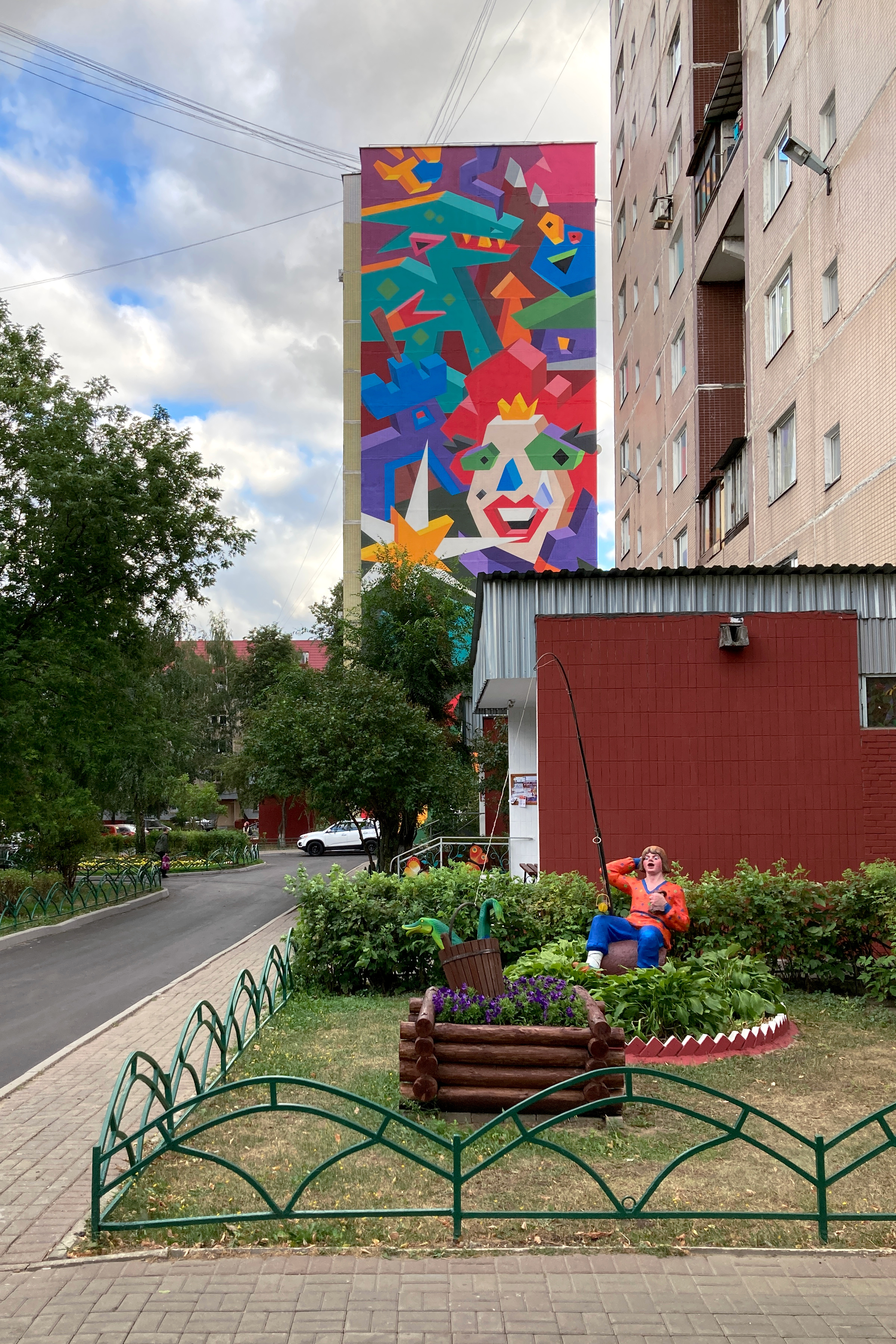 A colorful mural on a 12-story building.