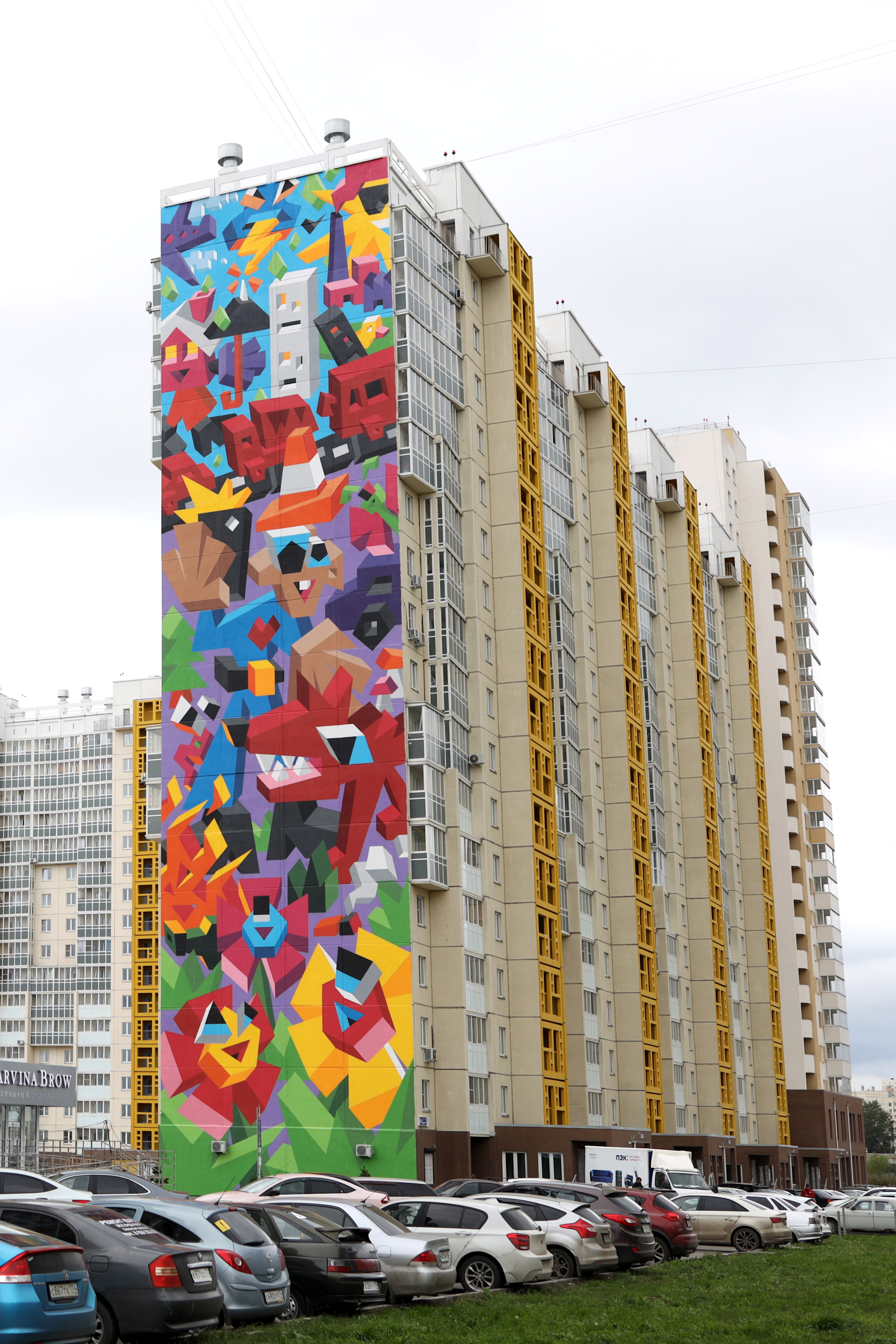 A colorful mural on an 18-story building.