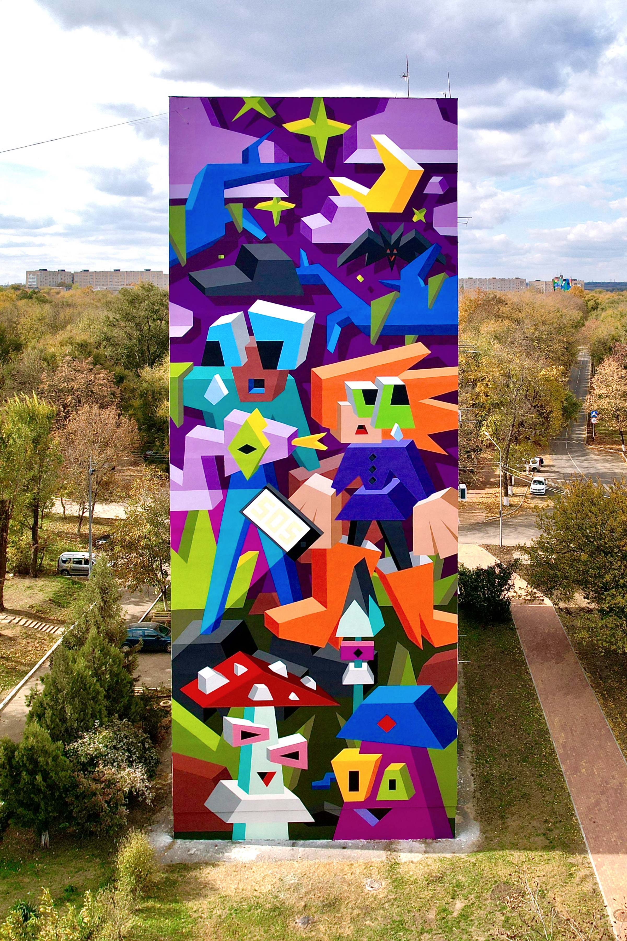 A colorful mural on a 9-story building.